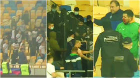 Police launch criminal hooliganism investigation after fans jump fence in stadium in bloody fight over flares during match (VIDEO)